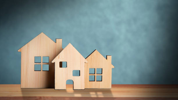 istock Small wooden houses on the table 1438475407