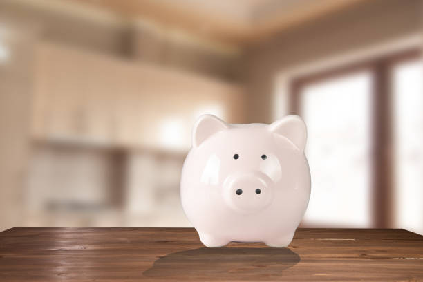 istock Piggy bank on a wooden table 1438475446