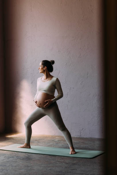 istock Pregnant Brunette Exercising In The Gym 1438477789