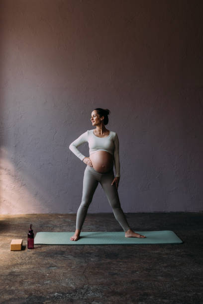 istock Pregnant Brunette Exercising In The Gym 1438477793