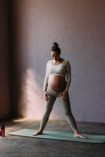 istock Pregnant Brunette Exercising In The Gym 1438477813