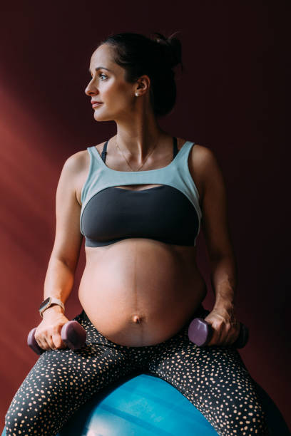 istock Pregnant Woman Relaxing In Between Exercises 1438477880