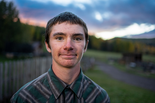 Portrait of Teenage Farm Boy on His Ranch in Southwestern Colorado Near Telluride in the Fall with a Dramatic, Colorful Sunset