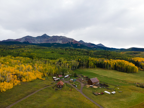 Aerial Drone View of Historic Mountain Ranch in Southwest Colorado in the San Juan Range of the Rocky Mountains Near Telluride with Vibrant Fall Colors on the Trees