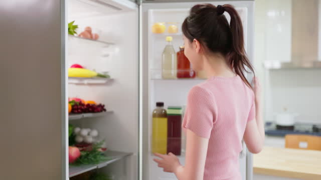 woman look at full fridge