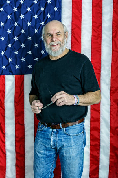 istock Bearded Senior Man Standing in Front of USA Flag 1438494709