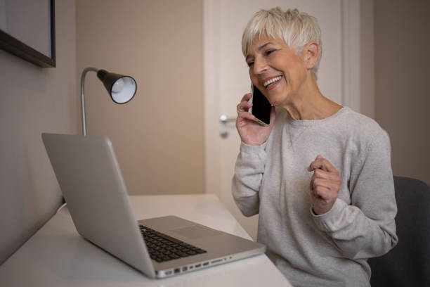 istock Senior woman working from home 1438494863
