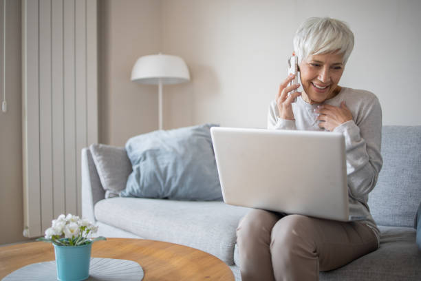 istock Senior woman working from home 1438494896