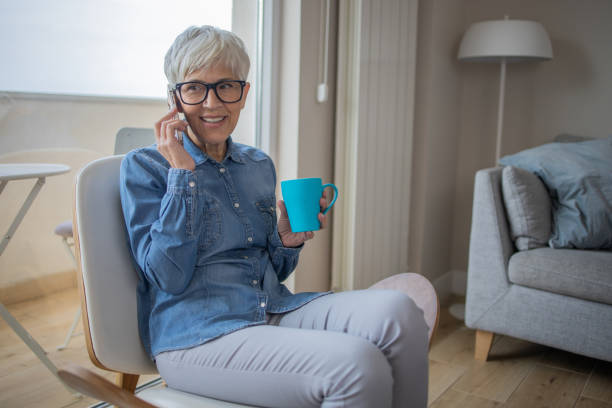 istock Happy senior woman using phone 1438495484