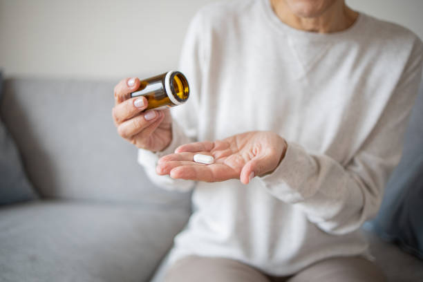 istock Senior woman taking pills 1438497044