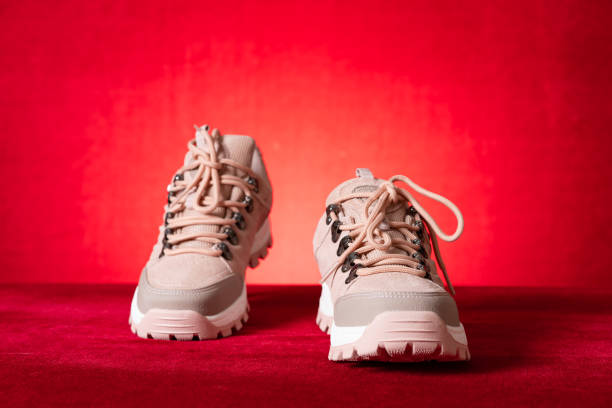 istock pink color hiking boots for lady on red 1438499319