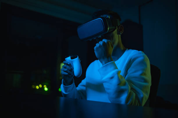 young man in vr glasses plays virtual reality game in metaverse universe and experiences different emotions