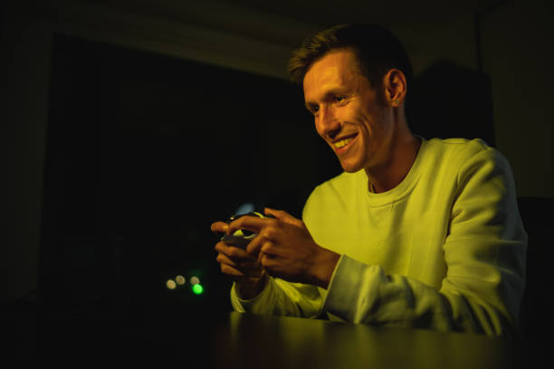 istock young man excitedly playing console game and winning and happy 1438500096