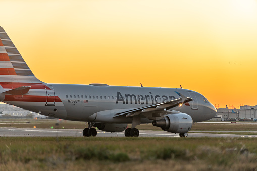 An airplane of American airlines taxiing on runway in Pearson International airport at dusk, Toronto,Canada.