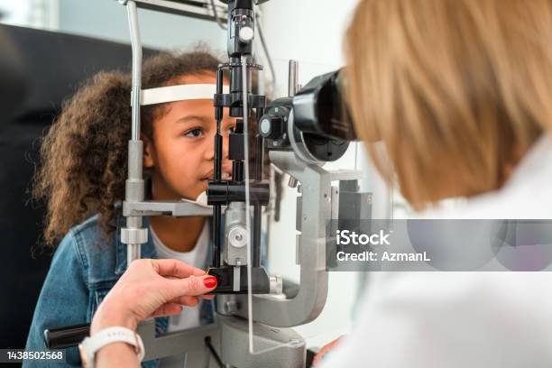 Curly Brown Hair Girl Sitting At Ophthalmologist Office Stock Photo - Download Image Now