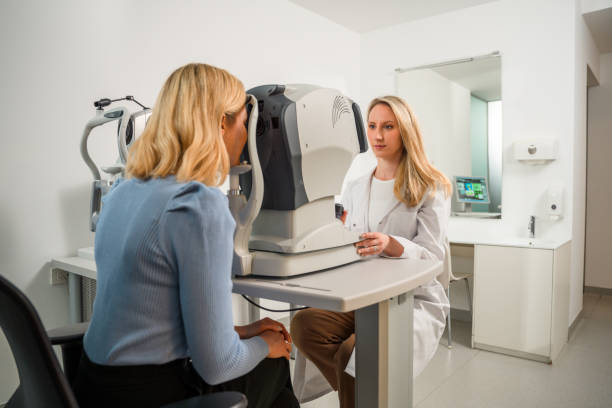 istock Young Professional Wearing a Lab Coat Helping Female Client 1438502587
