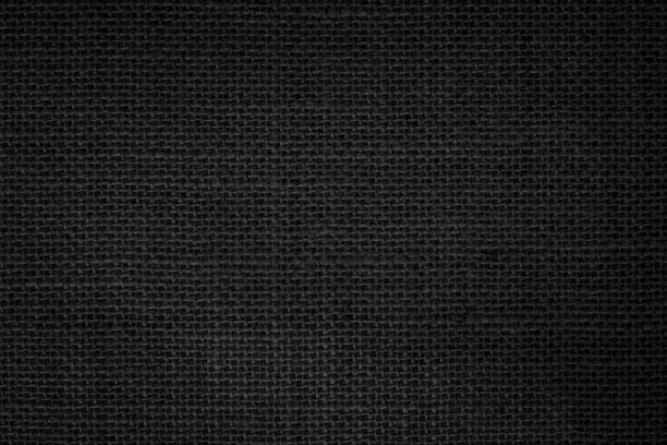 istock Black fabric canvas texture background. Linen dyed black. Sackcloth woven texture pattern background dark black color pipe from plant blade natural. Abstract vintage textured empty. 1438502893