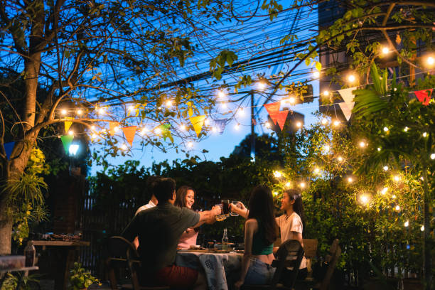 istock Evening group of friends drinking beer and clinking glasses. 1438504537