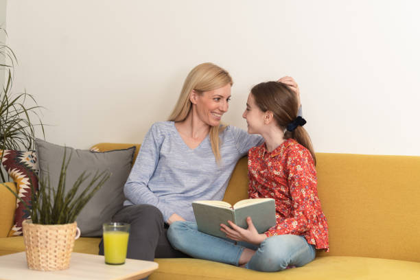 istock Mother with little daughter reading book together 1438504654