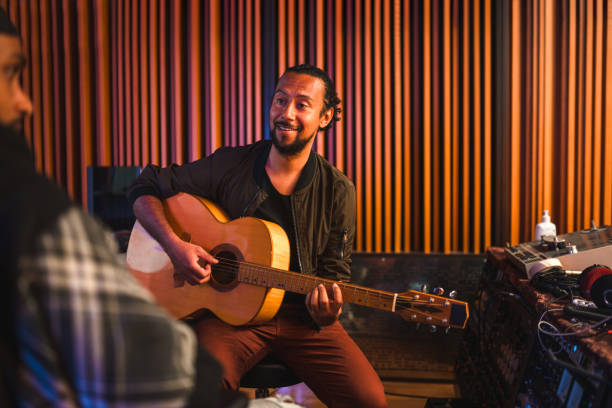 istock Two Male Musicians Composing Music in Recording Studio Mixer 1438504733