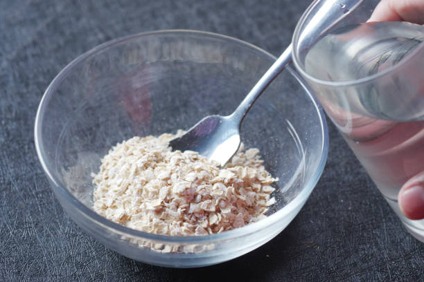 istock putting water in raw oats flakes in a bowl 1438507890