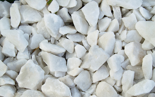 Background natural material - white pebbles, gravel, stones for laying paths in the Park, top view