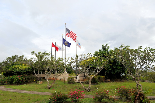 Saipan, Nortern Mariana, USA- February 10, 2011: Saipan is a small island in the Western Pacific Ocean, part of the Commonwealth of the Northern Mariana Islands. It is a leading resort in the Northern Mariana Islands for its beautiful beach and well preserved environment. Here is the view of a park, where American National Flag and North Mariana Flag can be seen.