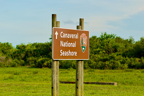 Titusville, Florida, USA - May 29, 2020: A National Park Service sign directs visitors to Canaveral National Seashore at NASA’s Kennedy Space Center.