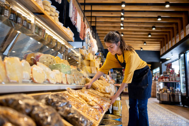 istock Retail clerk restocking a stall at a supermarket 1438530484