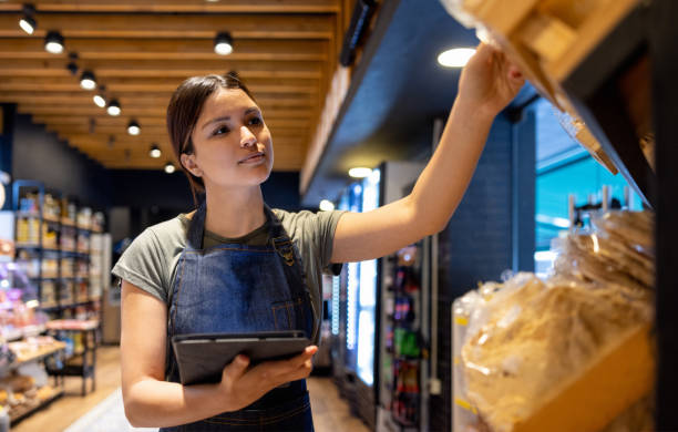 istock Retail clerk working at a supermarket and doing the inventory 1438530661