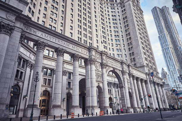 New York City, USA - April 28, 2015 : Incidental people in front of The David N. Dinkins Municipal Building