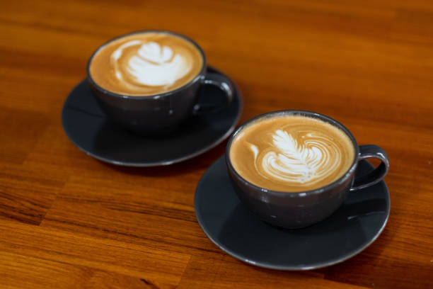 istock hot latte art coffee on wood table, relax time 1438538367