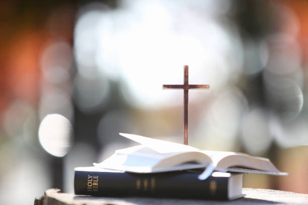 istock Bright light background with bible and holy jesus christ cross 1438538572