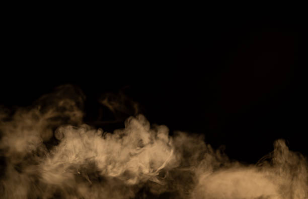 istock yellow smoke with black background, cloud 1438539485