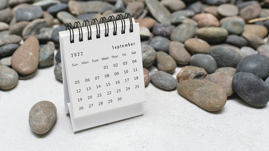 Calendar on concrete floor with pebble stone