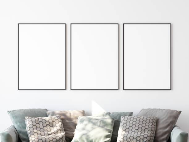 istock Three blank picture frames in row hanging on white wall in living room. Place for your content. 3D illustration. 1438540721