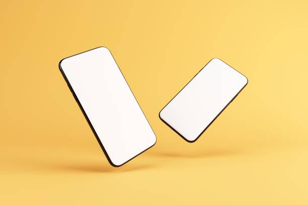 istock Two similar smartphone mock ups isolated on yellow background. Template with blank white screen for adding your content. 3D illustration. 1438541727