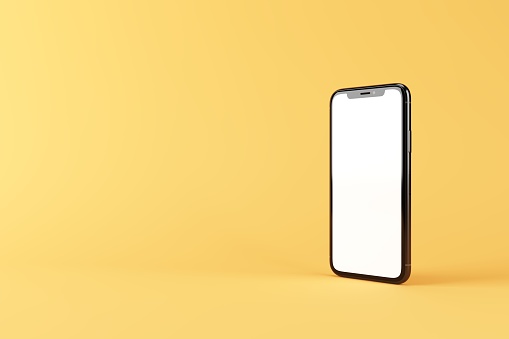 Standing rotated smartphone with blank white display. Mobile phone mock up isolated on yellow. 3D illustration.
