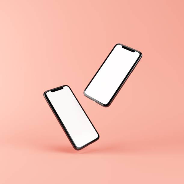 istock Two smartphone mockups isolated on pink. Template with blank white screen for adding your content. 3D illustration. 1438541772
