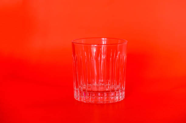 istock Transparent glass on red background 1438543585