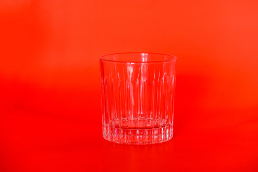 Transparent glass on red background