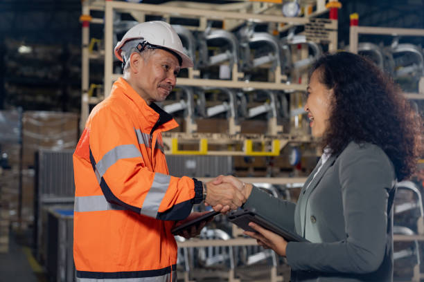 istock Male worker shaking hands with manager in warehouse. 1438543668