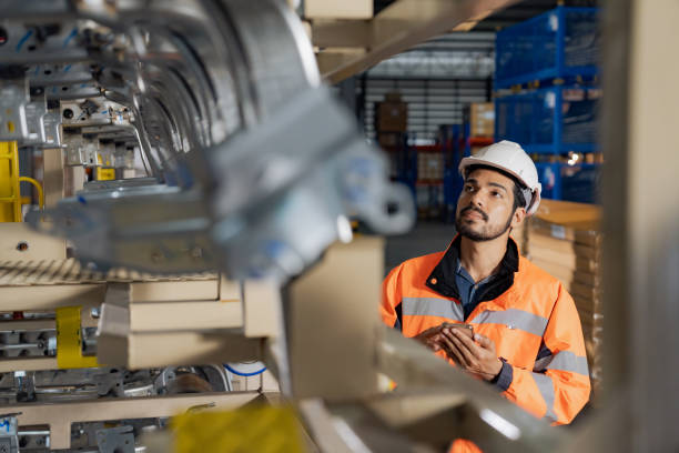 a day at work for a male and female engineers working in a metal manufacturing industry. - assemblagelijn fotos stockfoto's en -beelden