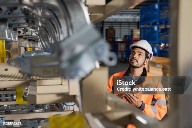 A Day At Work For A Male And Female Engineers Working In A Metal Manufacturing Industry Stock Photo - Download Image Now