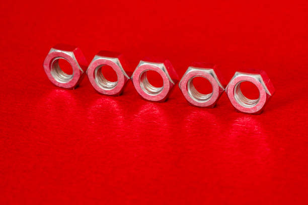 Image of five metal nut on red background