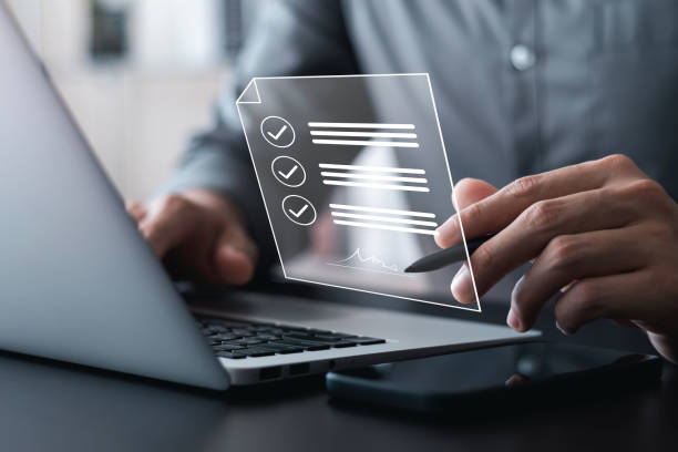istock Electronic signature concept, business man using stylus pen to approve digital document on screen like using stylus pen, paperless office Signing future business contracts. 1438545486