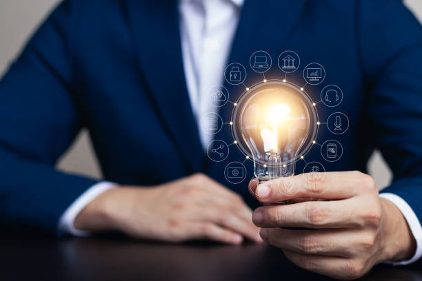 istock Innovation through ideas and inspiration ideas. Human hand holding light bulb to illuminate, idea of creativity and inspiration concept of sustainable business development. 1438545523