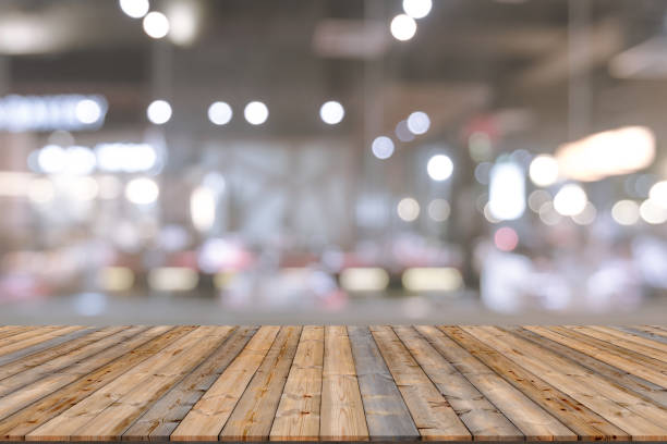 istock Wooden table with blur restaurant background 1438546648