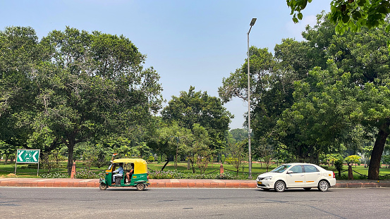 Connaught Place, New Delhi, India - October 5, 2022: Auto rickshaw transporting passengers at Connaught Place, one of the largest business, commercial and financial centres in New Delhi, India.