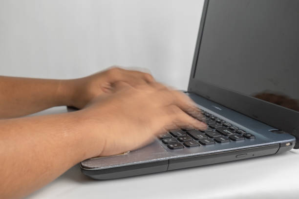 fast typing on keyborad motion blur of fast hand typing on laptop keyboard keyborad stock pictures, royalty-free photos & images